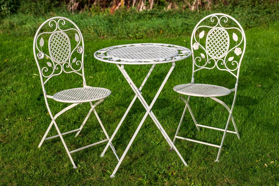 Yoxford cream metal garden bistro set on a small UK balcony with potted herbs and lavender
