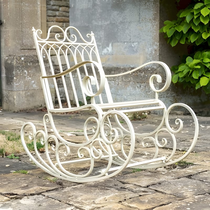 Heritage cream metal garden rocking chair on a flagstone patio