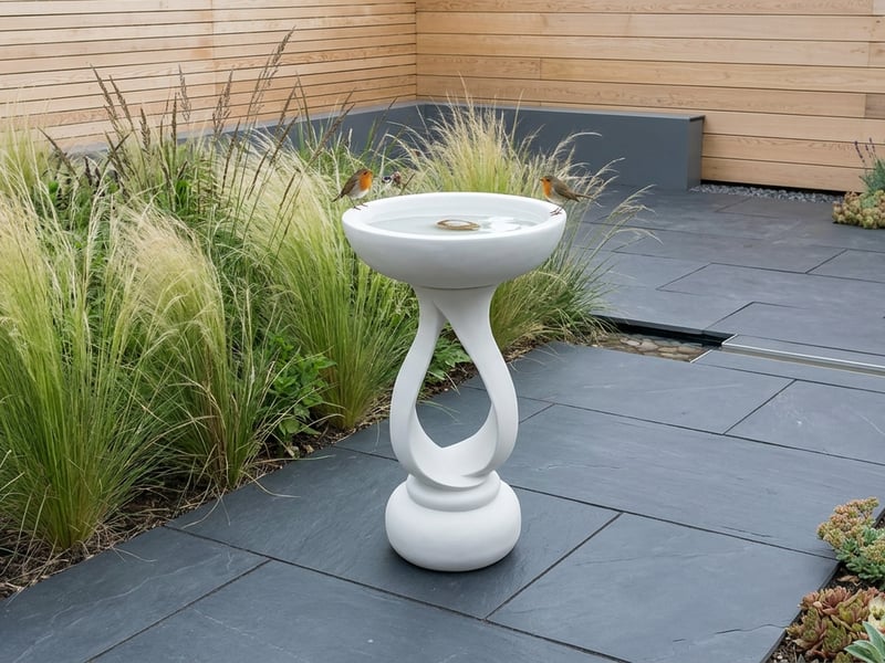 Enigma Contemporary Bird Bath in White in a modern garden setting