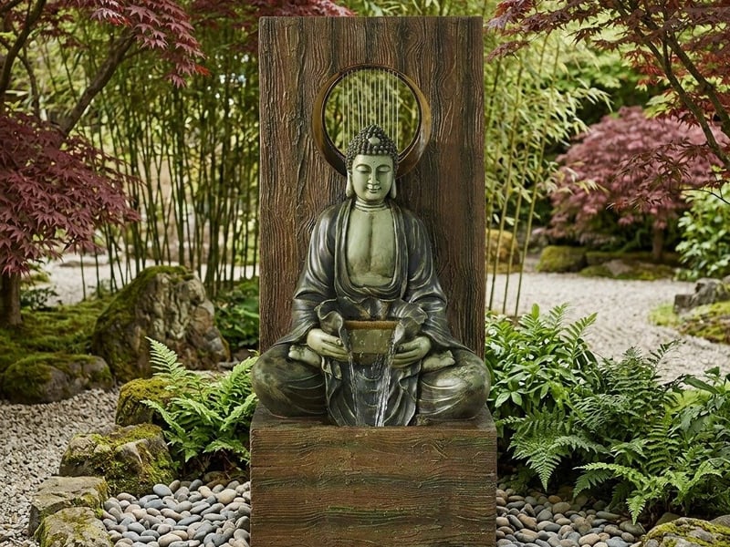 Heavenly Buddha self contained water feature in a zen garden setting with raked gravel and bamboo