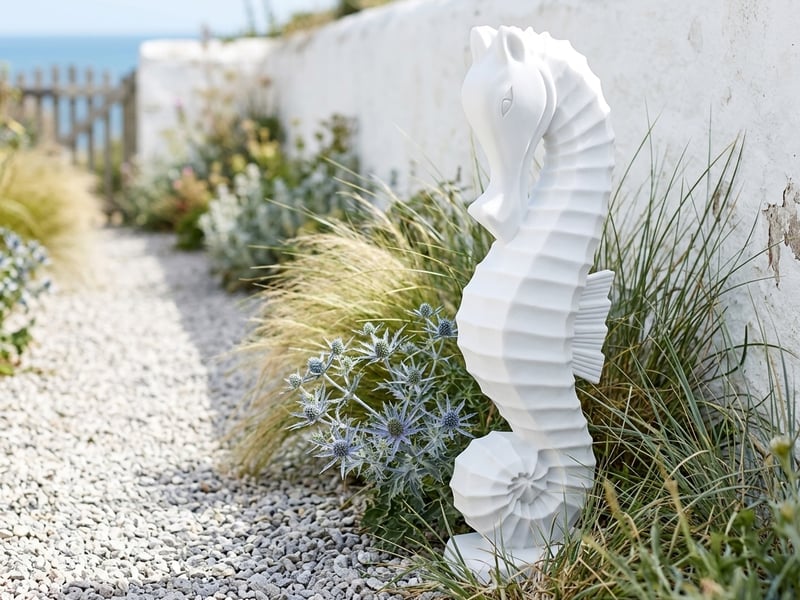 Large Seahorse Garden Ornament in white crushed marble resin in a coastal garden setting - coastal garden ornaments uk