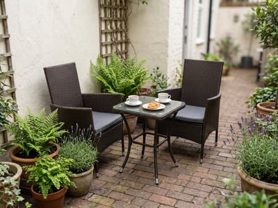 Brown rattan 2-seater bistro set on a small UK city courtyard patio