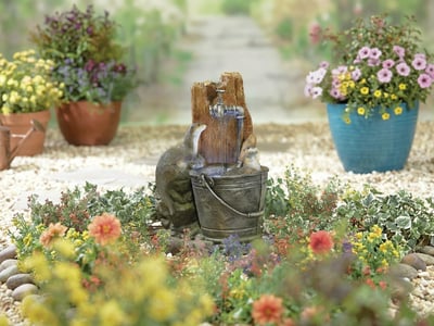 Bathing Otters small character self-contained water feature in a courtyard