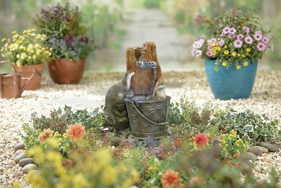Bathing Otters self contained water feature with two paired otters in the south-west love corner of a UK garden