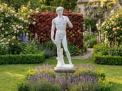 David Garden Statue in White displayed in an English cottage garden with lavender and roses