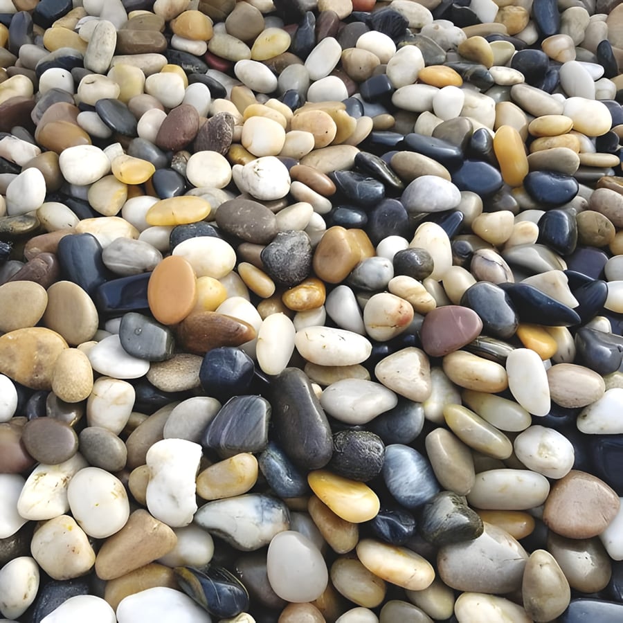 Mixed polished garden pebbles used as bee landing stones inside a stone water feature basin