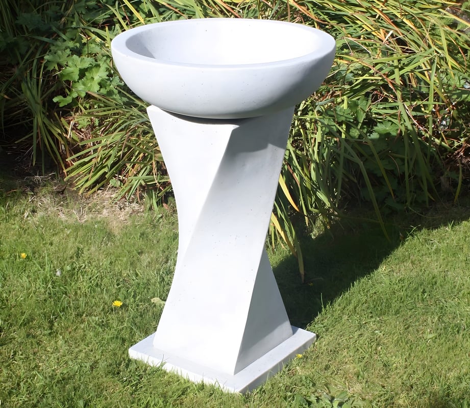 Twisted granite stone bird bath with sculptural pedestal in a UK garden buying guide