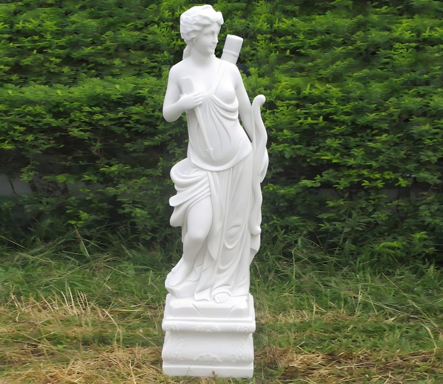 Diana the Hunter classical garden statue showing the small version positioned in a UK back garden border