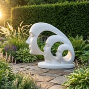Evolution Garden Statue in White on a natural stone patio in a garden setting