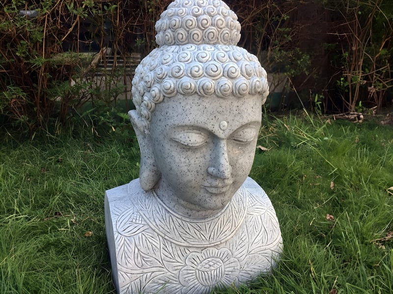 Champa Head Bust Eastern Khmer style stone garden ornament in a courtyard setting