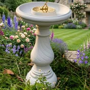 Swirl Stone Sundial in White in Cottage Garden