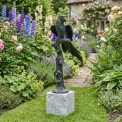 Parrot on Marble Base Metal Garden Ornament in English cottage garden setting