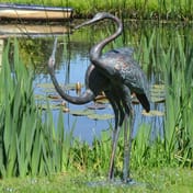 Small Love Cranes Iron Garden Ornament Beside Pond With Water Lilies