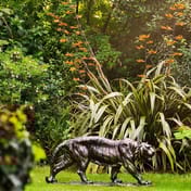 Small Tiger Metal Garden Ornament in a Lush Garden Setting