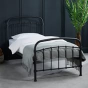 halston black single metal bed dark room shot