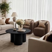 lane black round coffee table boucle chair scene