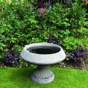 Edwardian Stone Birdbath in a traditional garden setting with fluted plinth detail