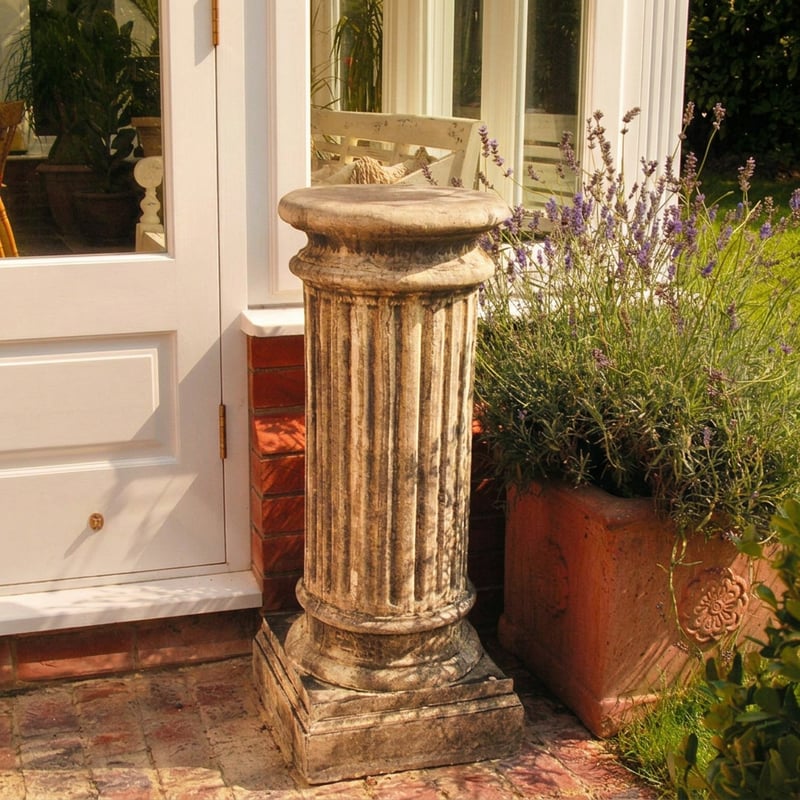 Oxford stone column garden pedestal in Cotswold stone finish beside a herbaceous border