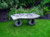 Wealdon Stone Garden Bench with looping legs in garden setting