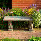 Straight Plain Stone Garden Bench in a colourful cottage garden setting