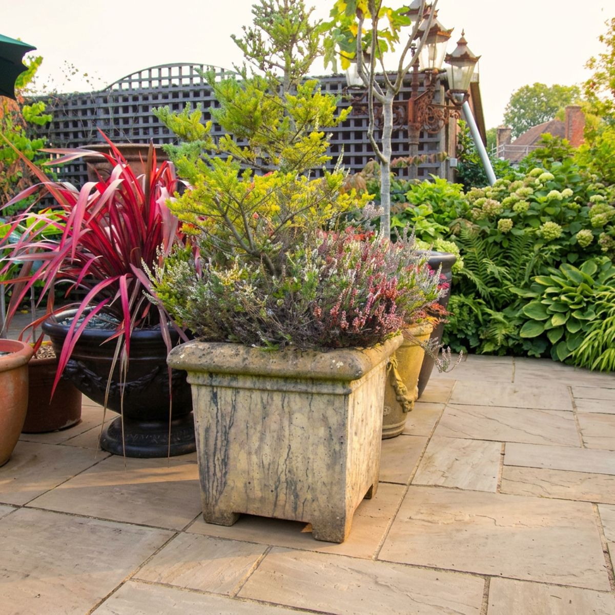 Grand Square Stone Garden Planter on a paved terrace