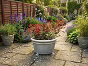 Grand Stone Garden Flower Pot on English cottage garden patio with weathered flagstones