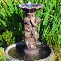 Stone cherub water fountain