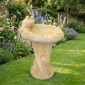 Dove Birdbath in Sand Stone in a cottage garden setting
