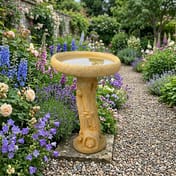 Fox Birdbath in Sandstone in a cottage garden setting