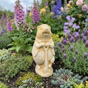 Hedgehog with Spade Stone Garden Ornament in Sandstone - Cottage Garden Setting