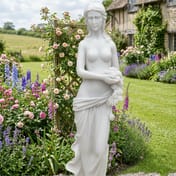 Isobelle Garden Statue in White displayed in a cottage garden setting