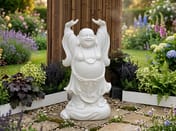 Cheering Buddha Garden Statue in White in a cottage garden setting