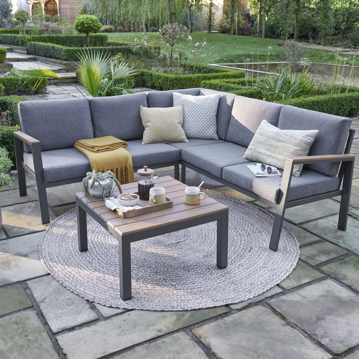 Norfolk Collection Easton anthracite mini corner garden set in dark grey rattan with polywood table, sized for small UK patios