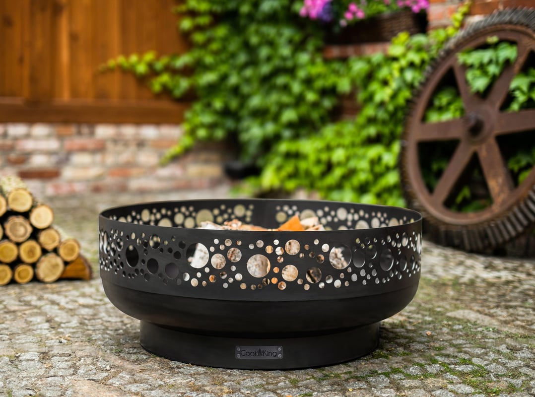 Cook King Boston 80cm decorative steel fire bowl with cut-out side panels in a UK garden