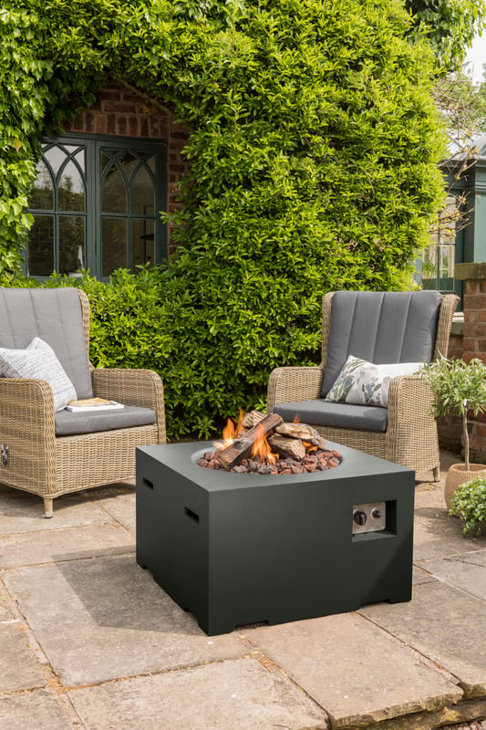 Happy Cocoon 76cm square Corten steel fire pit in black finish during the early patina phase in a UK garden