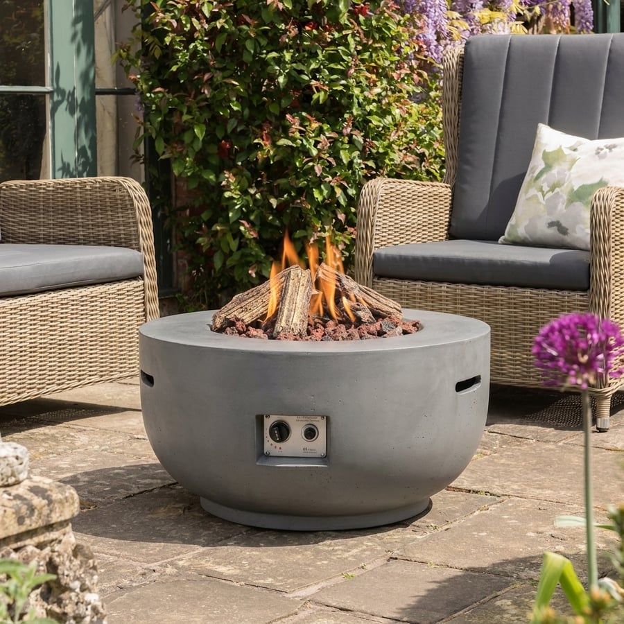 Happy Cocoon 91cm round bowl grey wood-burning fire pit in a large UK country garden entertaining setting