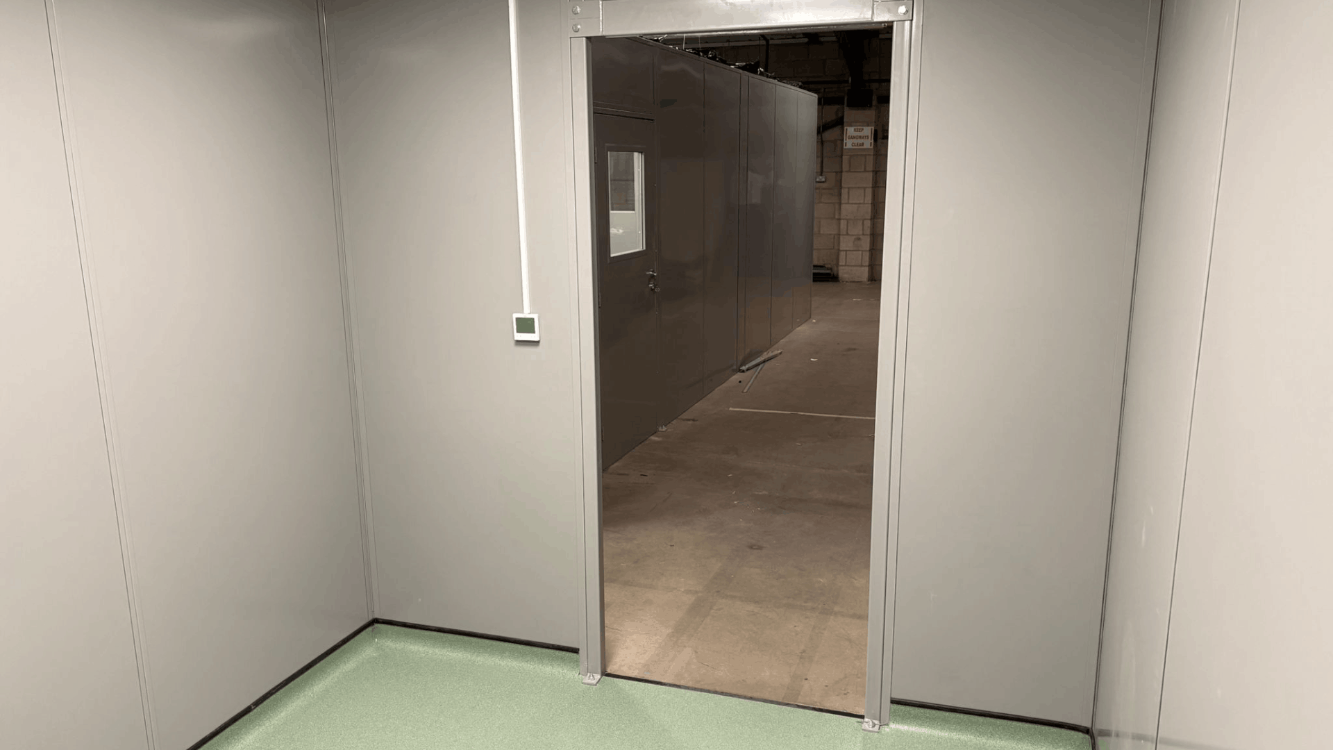 Clean room access opening from the molymer moulding services enclosure into the surrounding warehouse area.