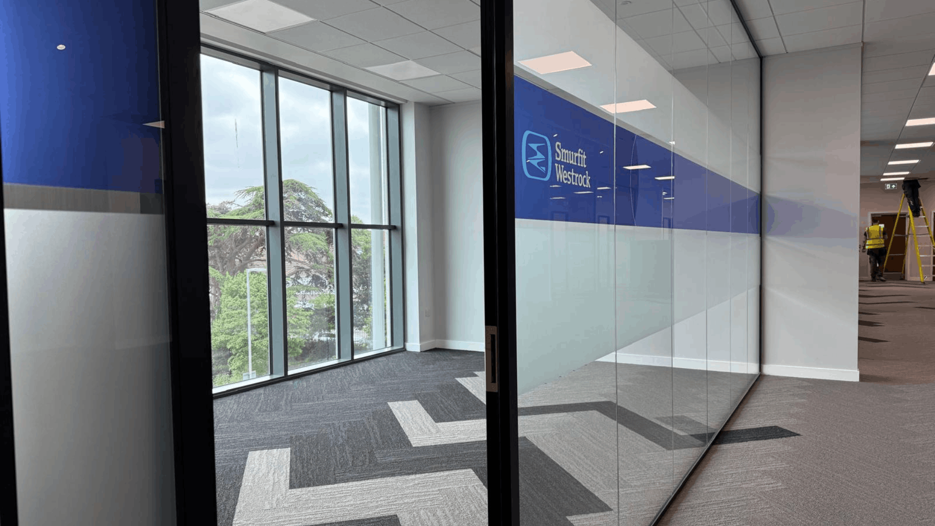 Smurfit westrock glass meeting room with branded manifestation and natural light from full height windows