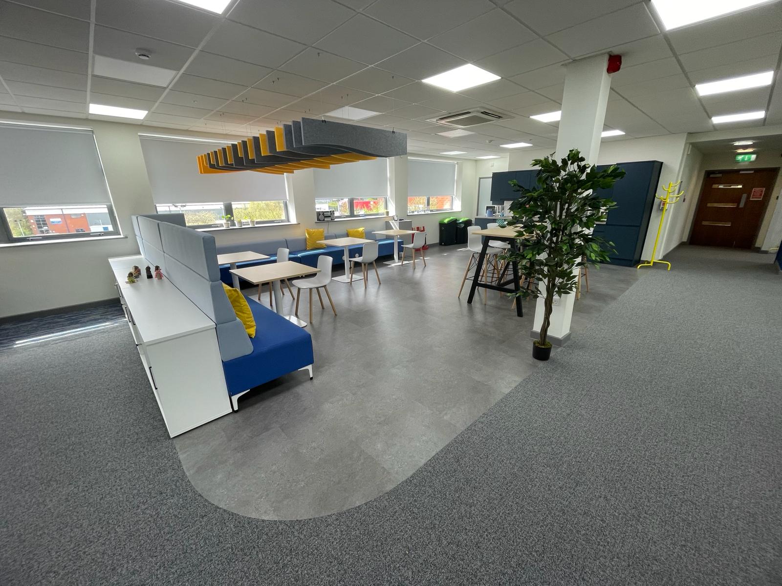 Breakout area in the card factory wakefield office refurbishment with acoustic ceiling baffles, booth seating, high table and new lvt flooring