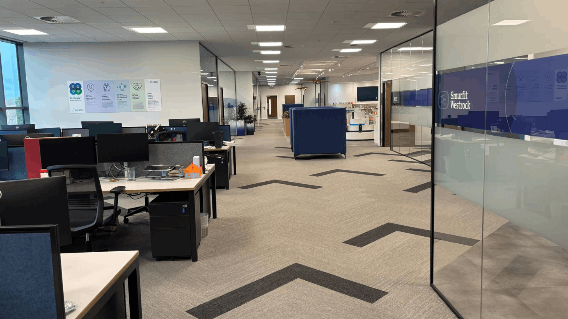 Open-plan office area at smurfit westrock with desks, glazed partitions and branded meeting rooms