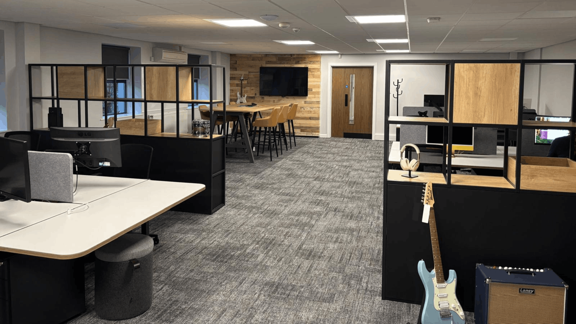 Refurbished headstock group open-plan office with new desking, feature dividers, carpet tiles and informal meeting area