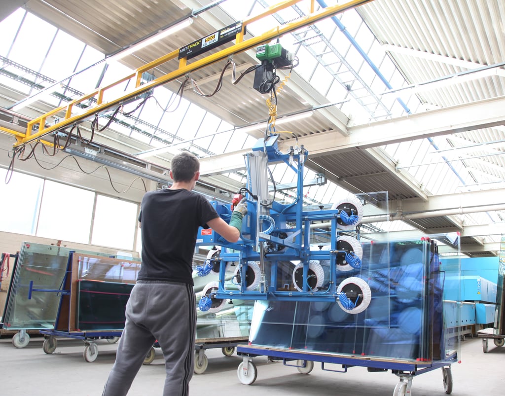 a man operating a met-track workstation bridge crane in a facility 