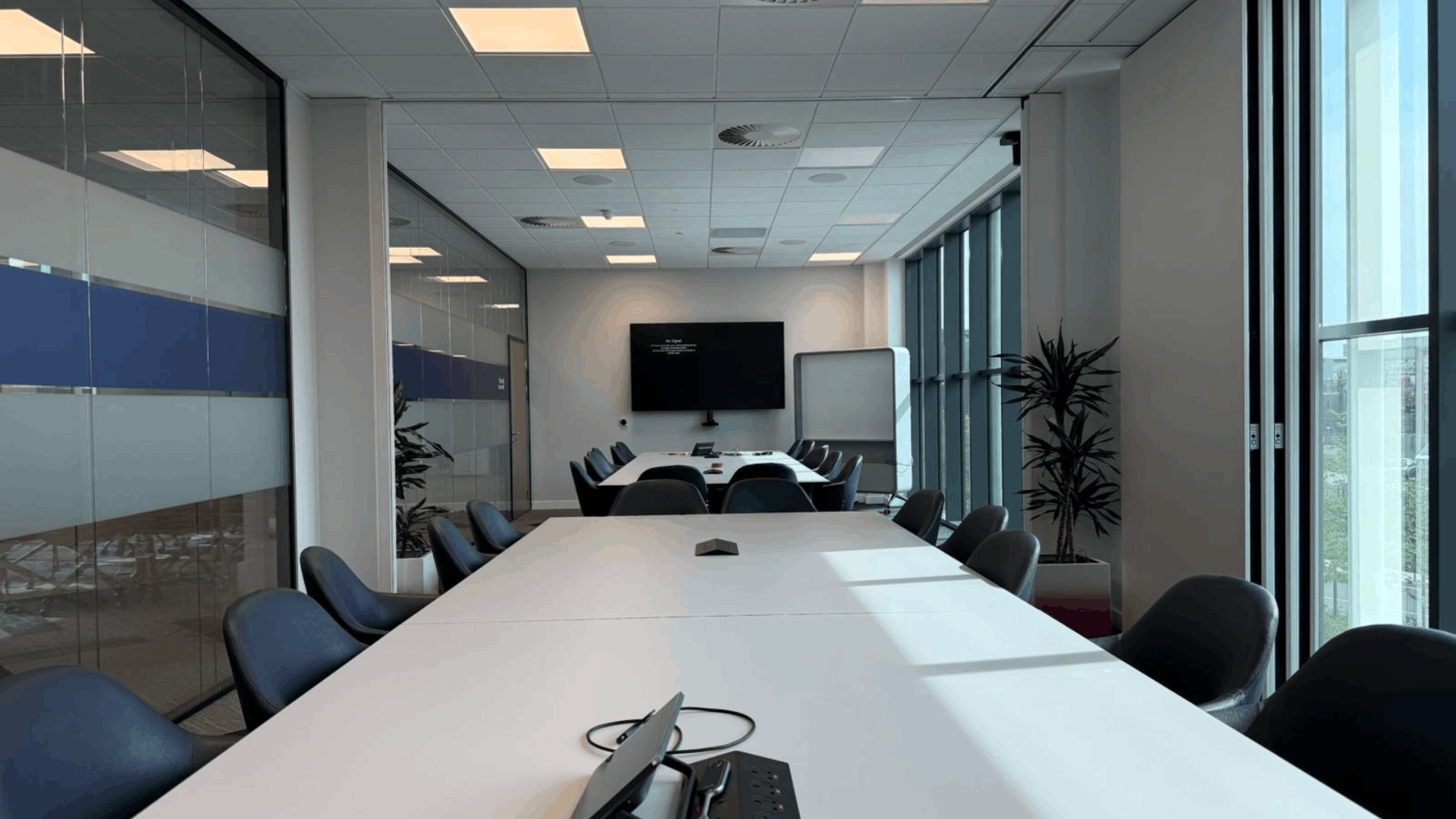 Smurfit westrock boardroom with long meeting tables, presentation screen and full height windows