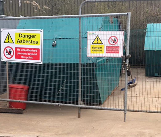 Asbestos Skip within a locked compound on concrete floor