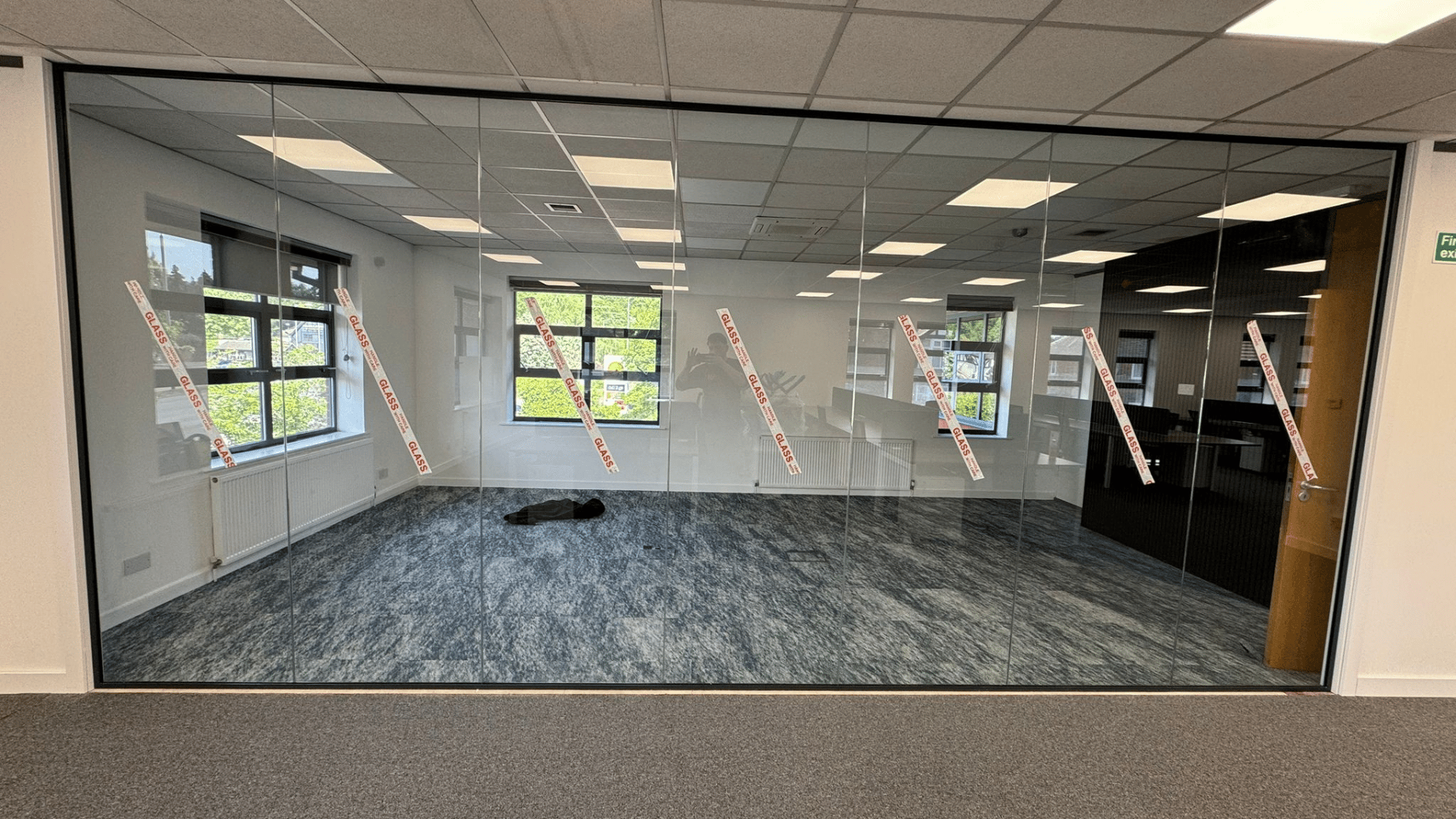 Full-height glass partitioning for the dsl systems office fit out separating the boardroom from the surrounding office space
