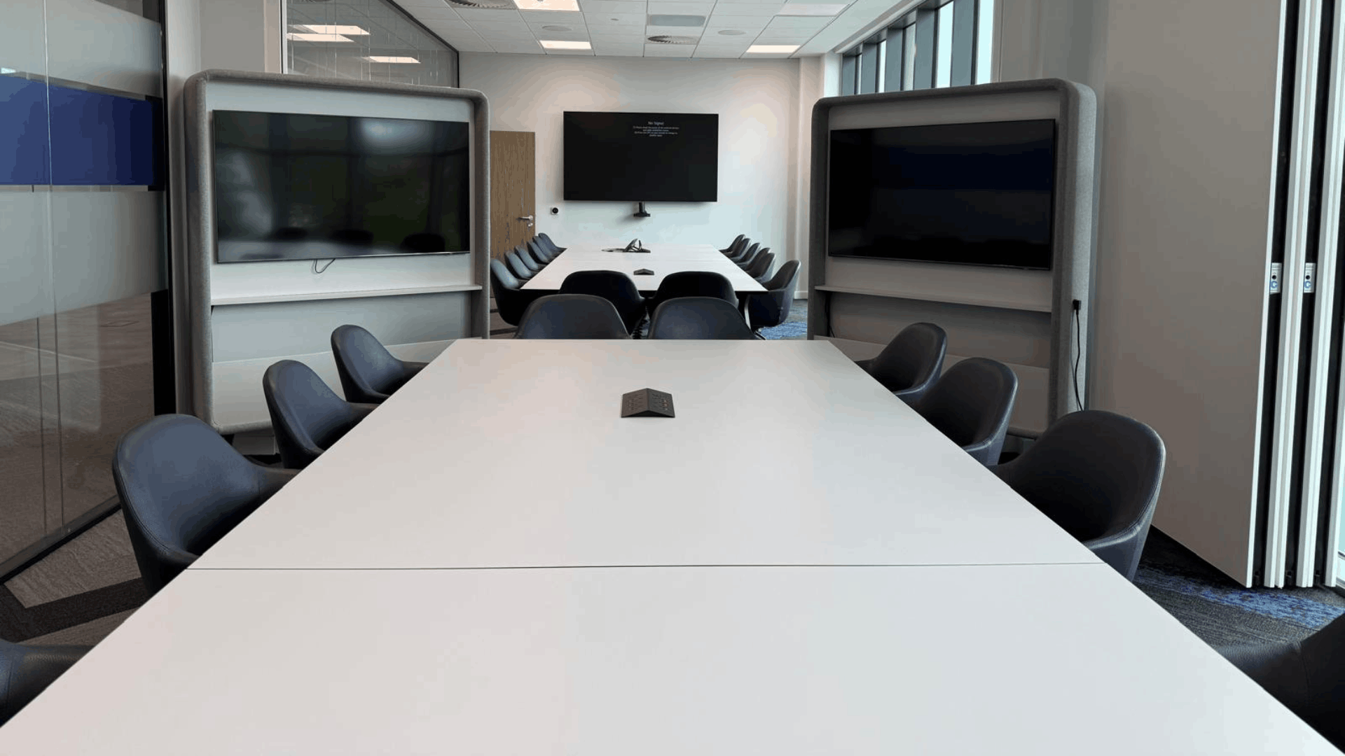 Smurfit westrock meeting room with large conference tables, presentation screens and acoustic media units