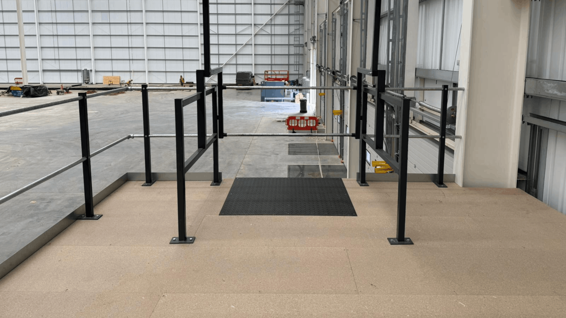 Completed mezzanine floor at smurfit westrock with safety handrails and warehouse access below