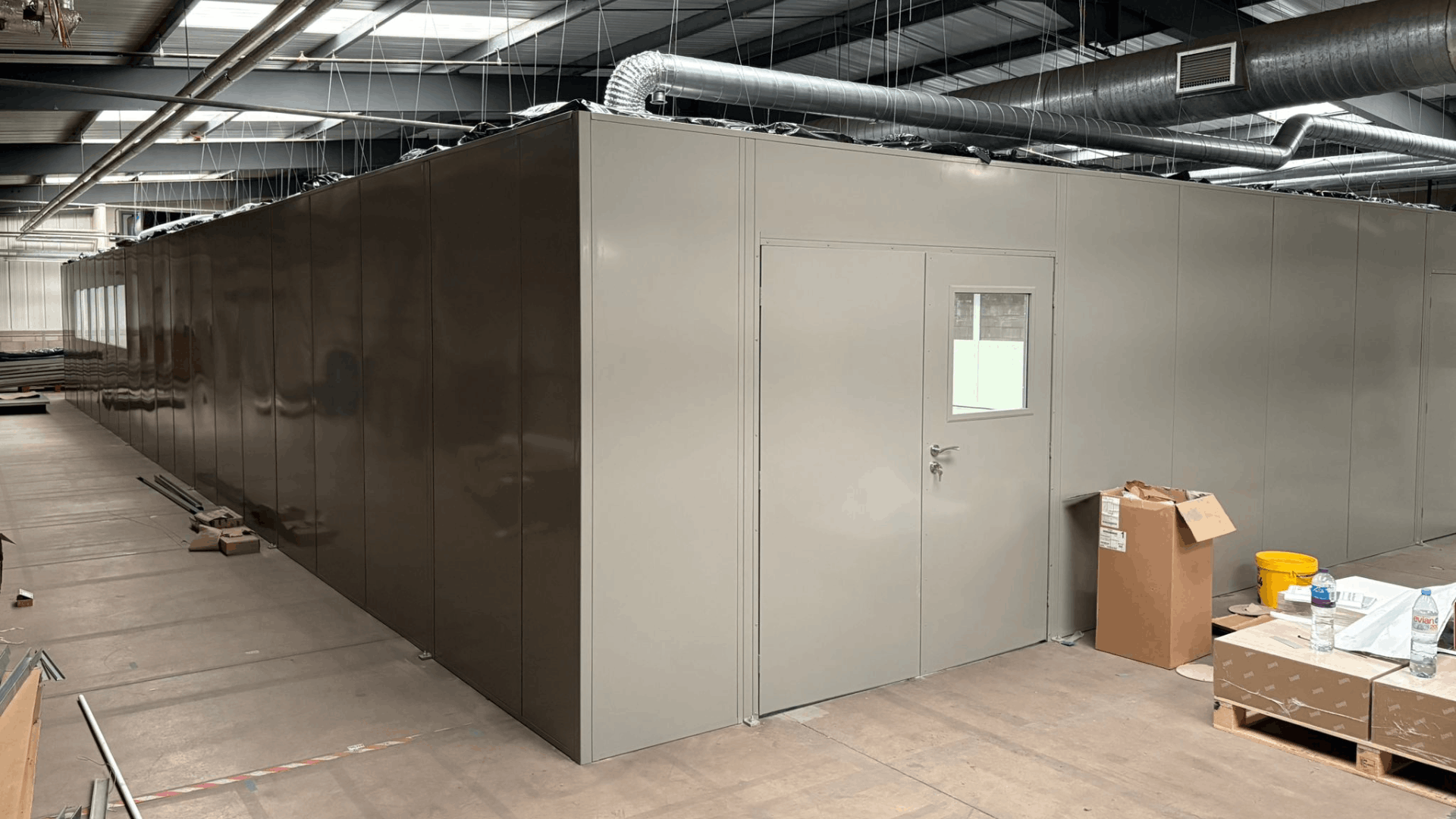 External view of the molymer moulding services clean room enclosure with double skin steel partitioning and integrated access door.
