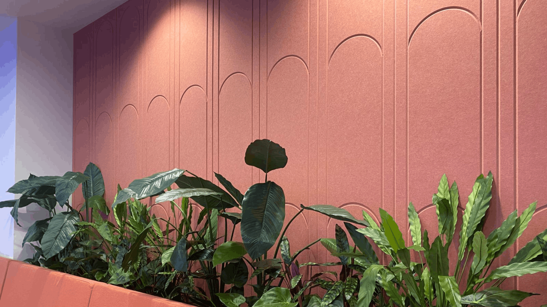 Terracotta acoustic feature wall with planting in the refurbished nec media suite breakout area
