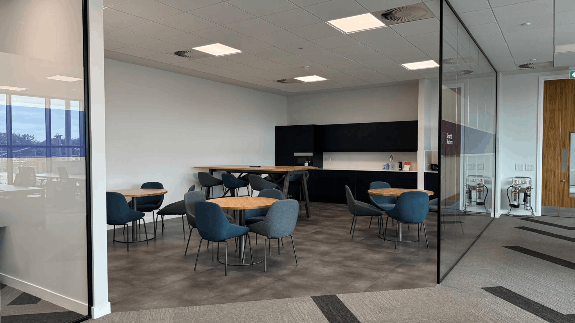 Completed smurfit westrock breakout area with tea point, round tables and soft seating